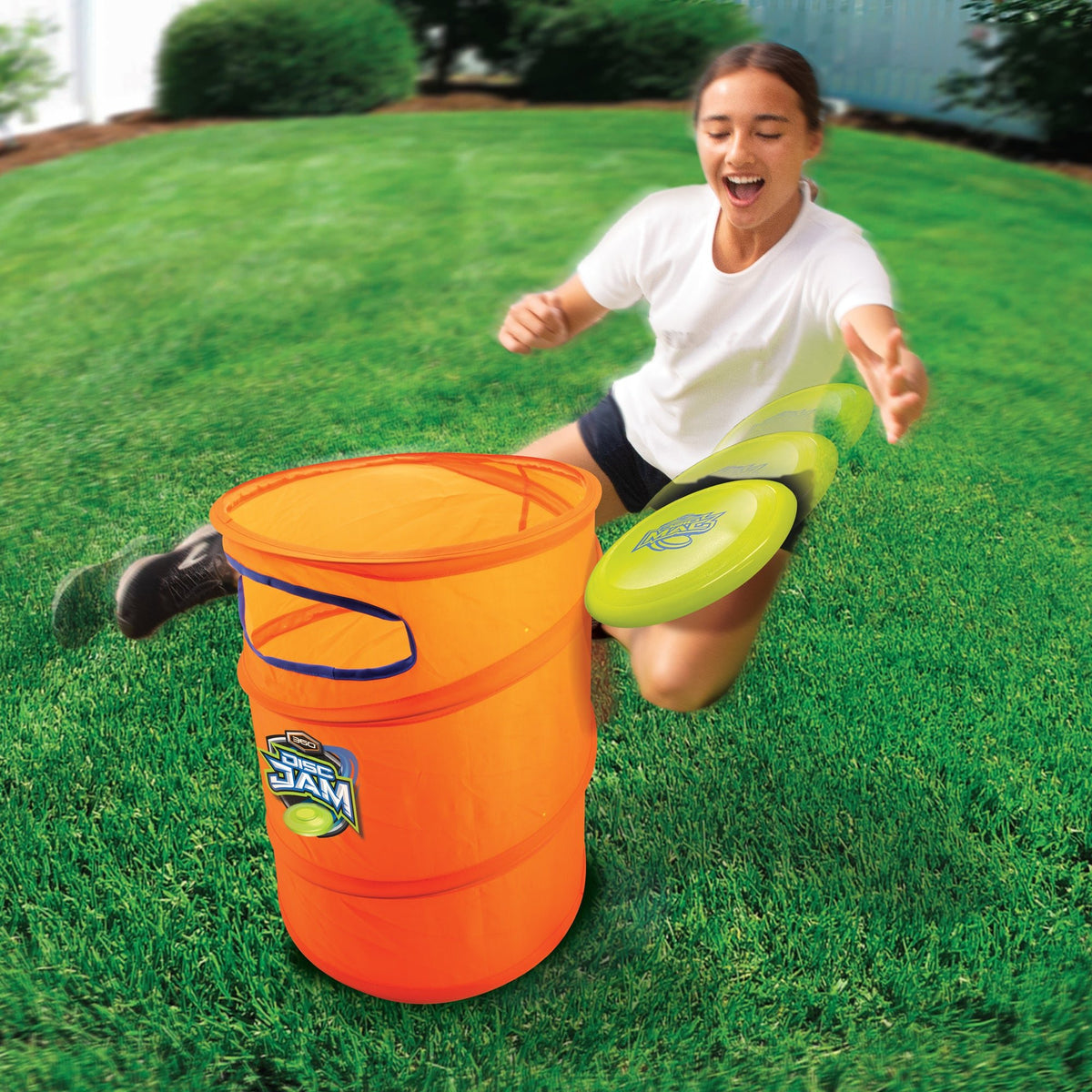 Person playing with a bucket and green flying discs on grass