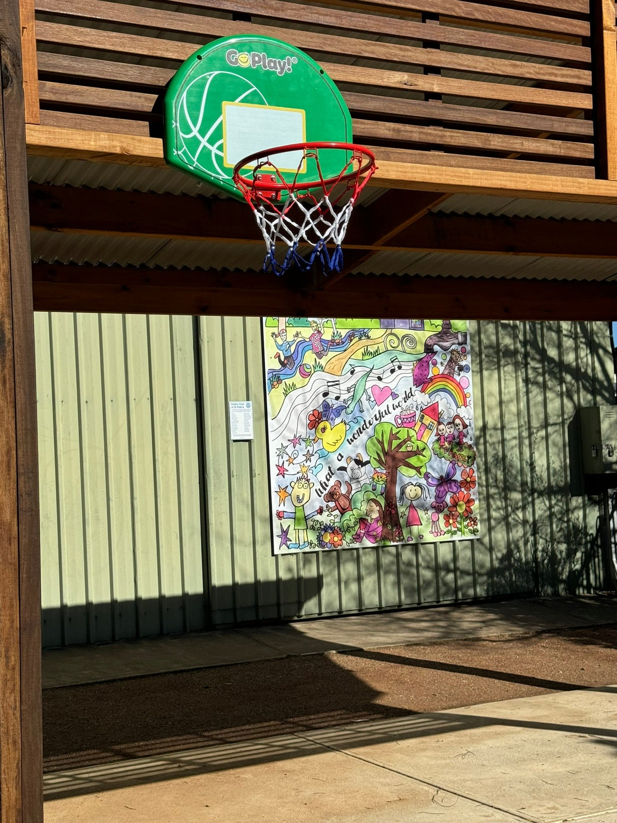 Image of basketball backboard and hoop attached to a tree in a gazebo