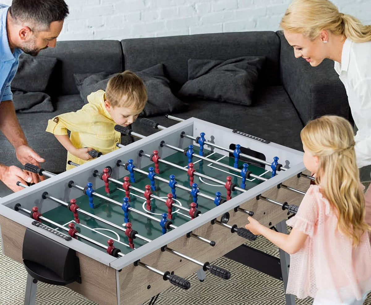Family playing foosball on the LOUIE table in a living room, with kids and adults enjoying a match together