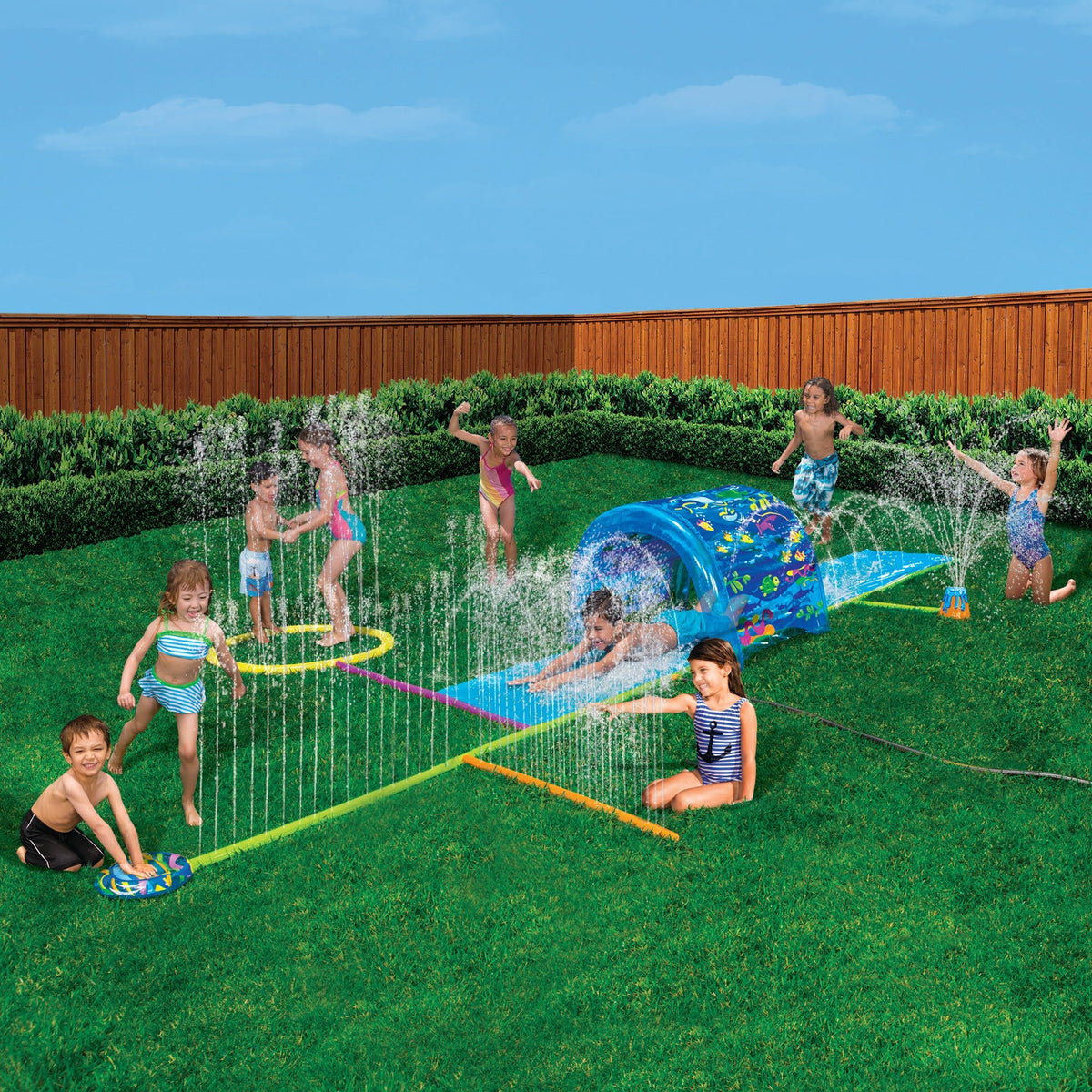Go Play! Splash 'N Slide Sprinkler Park setup on lawn, spraying water with children playing