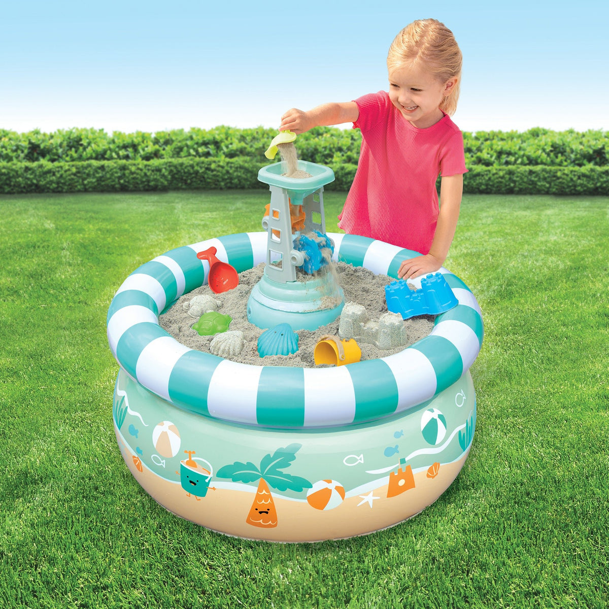 Child playing with an inflatable sand pit toy on grass