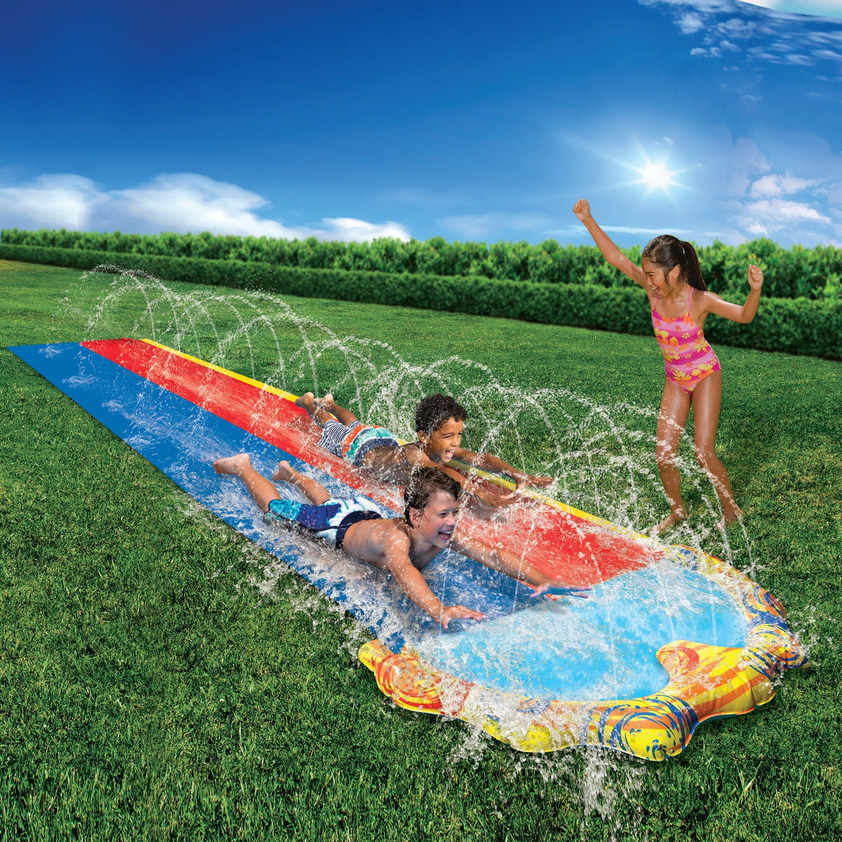 Go Play! Splash Sprint Racing Slide setup on lawn spraying water with 3 children playing