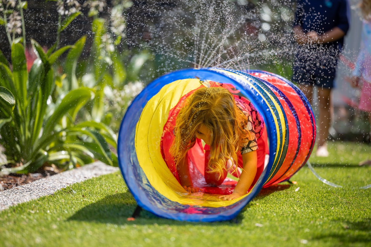 Girl crawling through Go Play! Sprinkle & Splash Tunnel