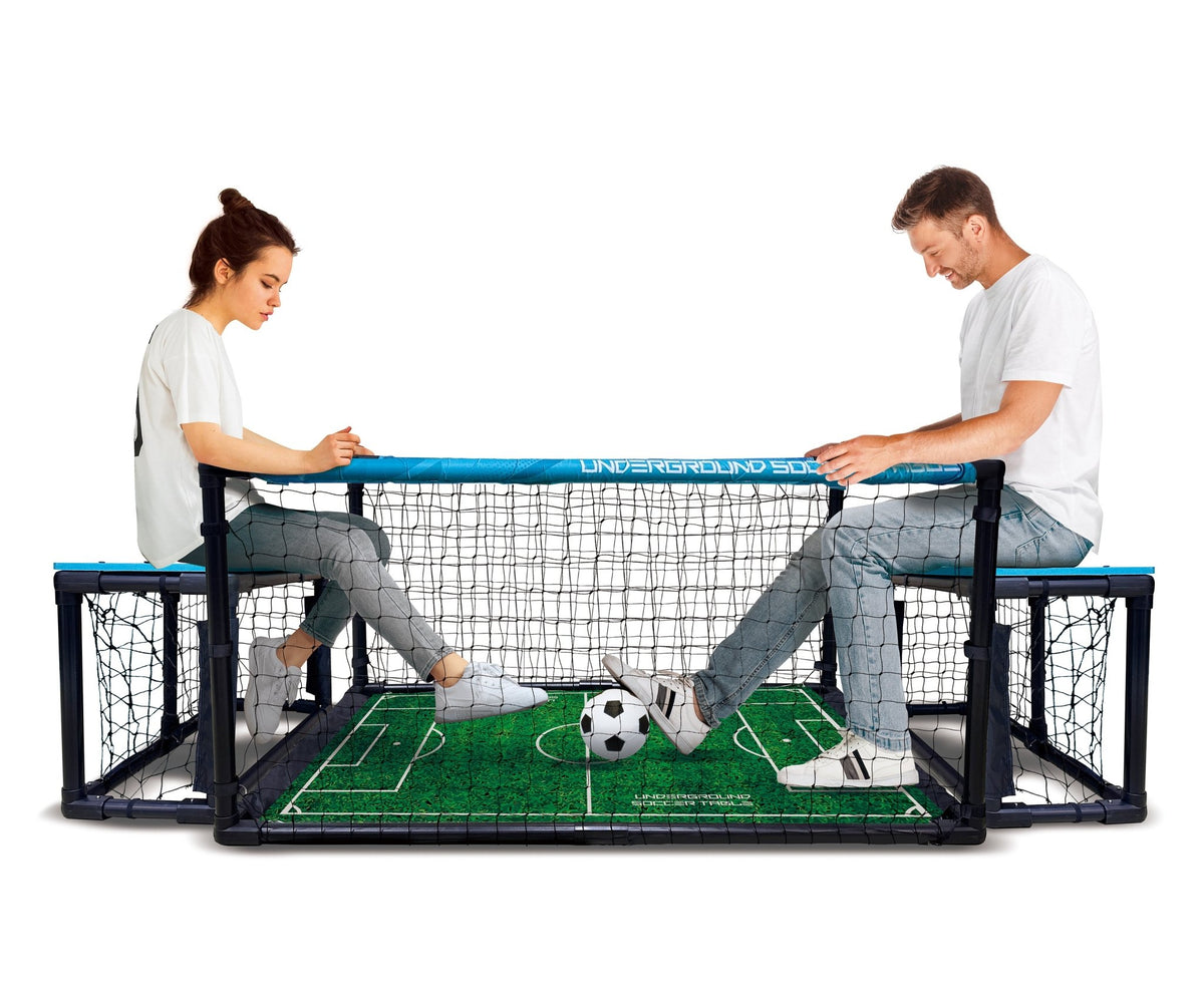 Two people playing with a bench soccer table on a white background