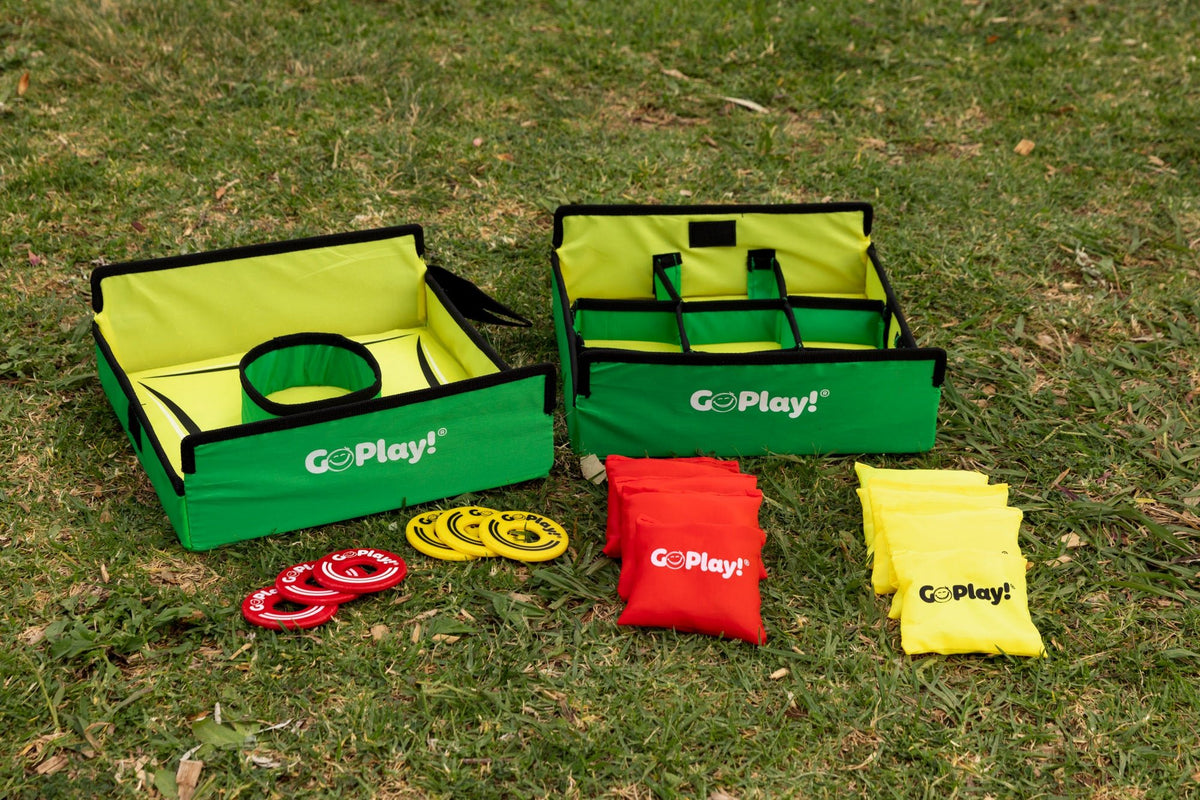 Go Play! washer toss and tic tac toss targets on grass with red and yellow washers and bean bags laid out in front
